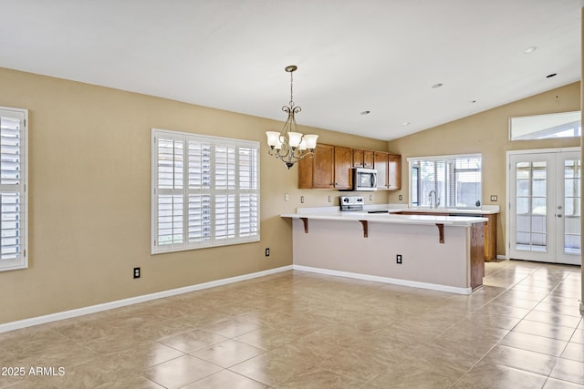 625 W Douglas Ave, Gilbert, AZ 85233 - kitchen featuring stainless steel microwave, brown cabinets, a peninsula, a chandelier, and electric stove