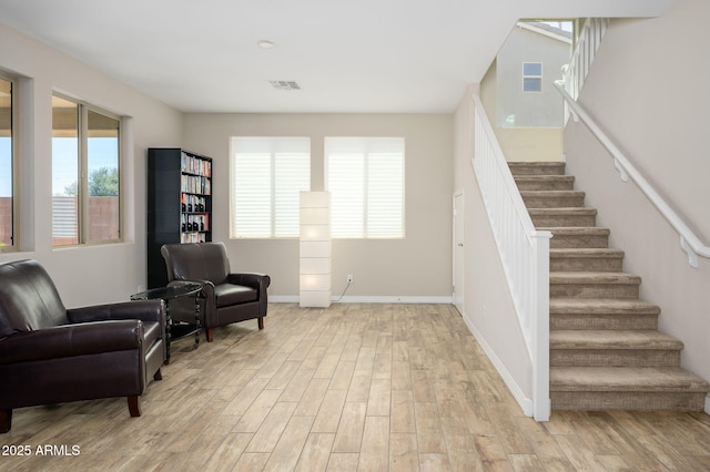 3247 E Creosote Ln, Gilbert, AZ 85298 - sitting room with stairs, light wood finished floors, and baseboards