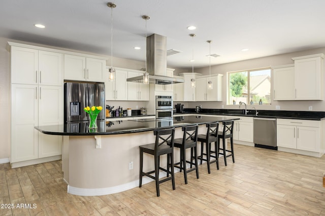 3247 E Creosote Ln, Gilbert, AZ 85298 - kitchen featuring stainless steel appliances, light wood finished floors, a breakfast bar area, white cabinets, and recessed lighting