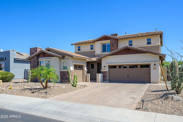 3247 E Creosote Ln, Gilbert, AZ 85298 - view of front of property featuring stucco siding, decorative driveway, stone siding, a garage, and a chimney