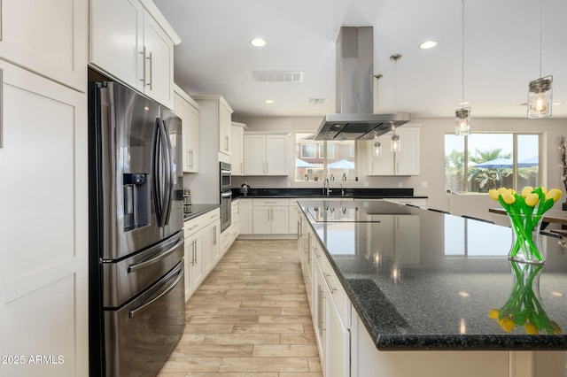 3247 E Creosote Ln, Gilbert, AZ 85298 - kitchen featuring stainless steel appliances, light wood-style floors, island range hood, a spacious island, and white cabinetry