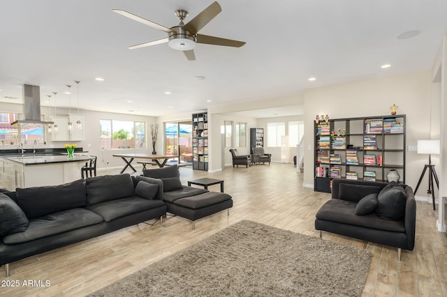 3247 E Creosote Ln, Gilbert, AZ 85298 - living area with light wood-style floors, baseboards, plenty of natural light, ceiling fan, and recessed lighting