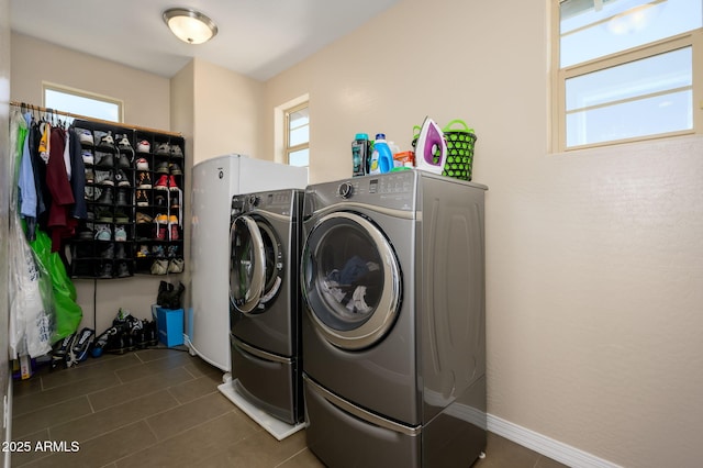 3247 E Creosote Ln, Gilbert, AZ 85298 - laundry area featuring washer and clothes dryer, healthy amount of natural light, and dark tile patterned floors