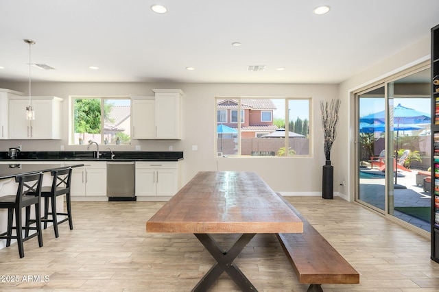 3247 E Creosote Ln, Gilbert, AZ 85298 - kitchen with stainless steel dishwasher, light wood-style floors, recessed lighting, and white cabinets