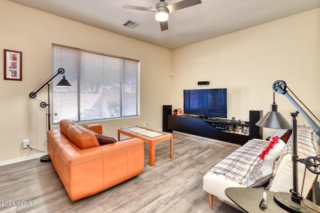 living room featuring ceiling fan and light hardwood / wood-style floors