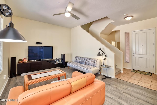 living room featuring ceiling fan and light hardwood / wood-style flooring