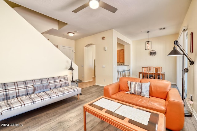 living room featuring ceiling fan and light hardwood / wood-style flooring