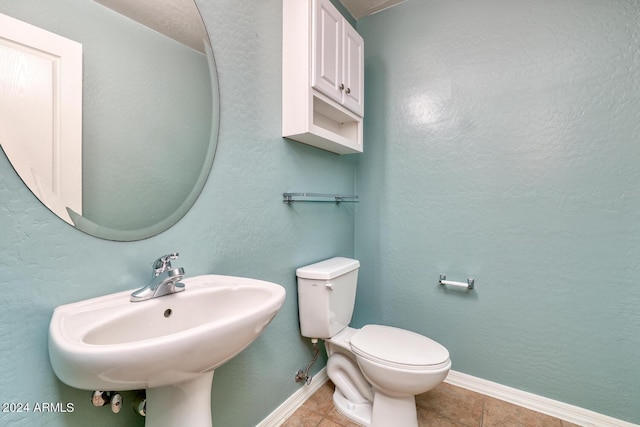 bathroom with tile patterned floors, toilet, and sink