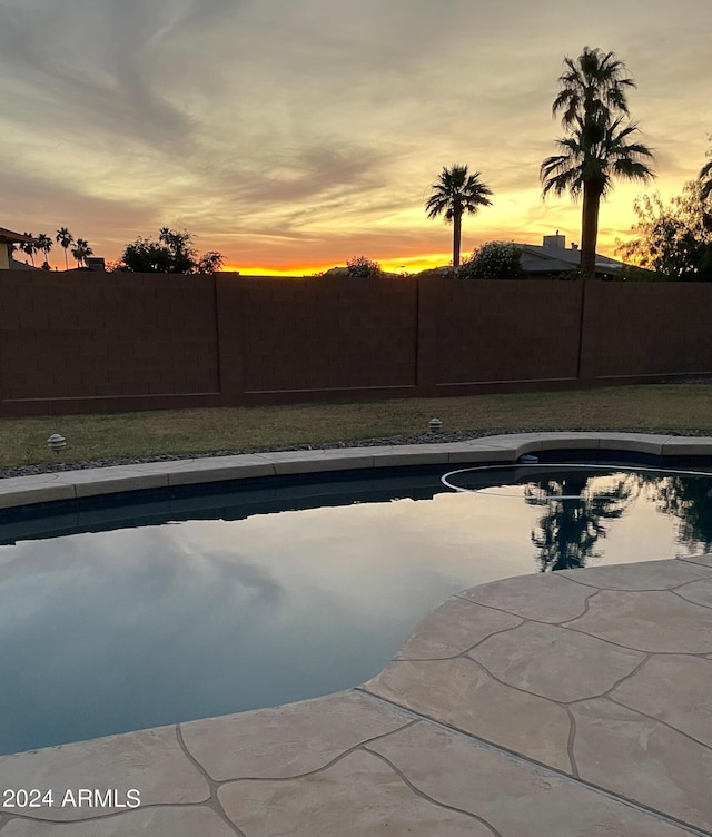 view of pool at dusk