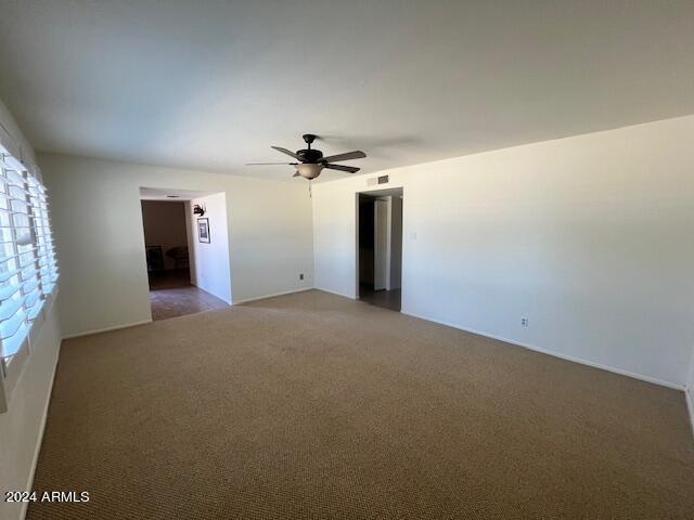 carpeted empty room with ceiling fan