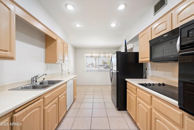 kitchen with light tile patterned floors, visible vents, light brown cabinetry, black appliances, and a sink