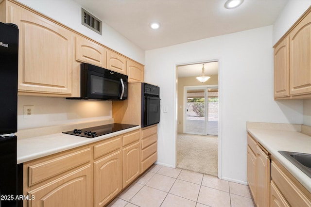 kitchen featuring light tile patterned floors, recessed lighting, visible vents, light brown cabinetry, and black appliances