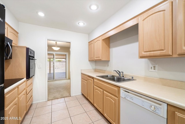 kitchen with dishwasher, oven, light brown cabinets, a sink, and light tile patterned flooring