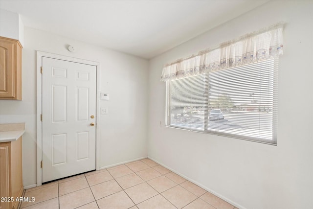 unfurnished dining area featuring light tile patterned floors