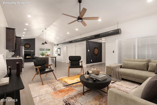 862 W Javelina Ave, Mesa, AZ 85210 - living room featuring vaulted ceiling, ceiling fan, recessed lighting, light wood-style flooring, and a fireplace