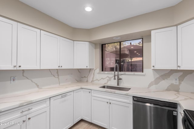 kitchen featuring white cabinetry, sink, light stone counters, and dishwasher