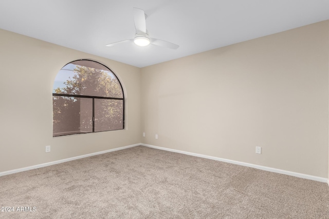 spare room featuring carpet floors and ceiling fan