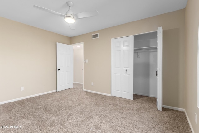 unfurnished bedroom featuring light carpet, a closet, and ceiling fan