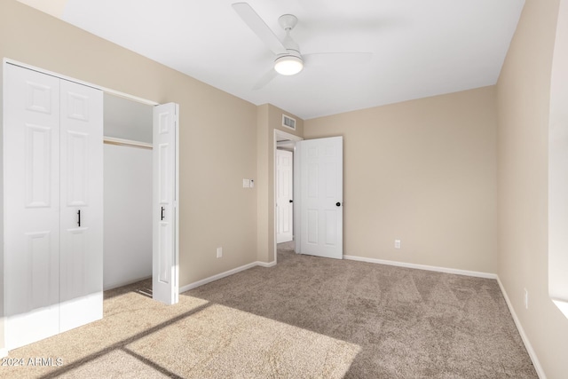 unfurnished bedroom with a closet, ceiling fan, and carpet