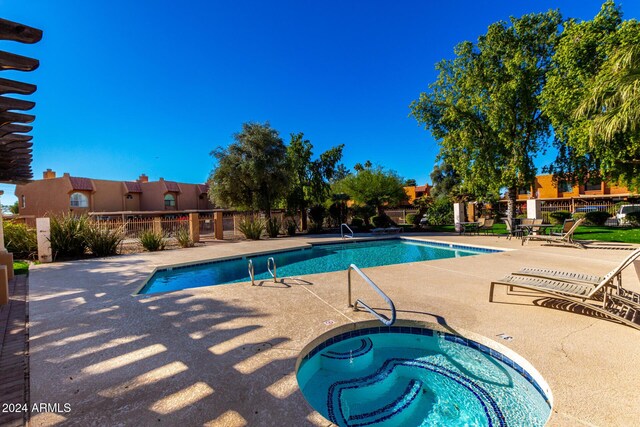 view of pool with a patio area and a hot tub