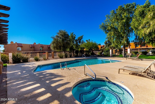 view of pool featuring a community hot tub and a patio