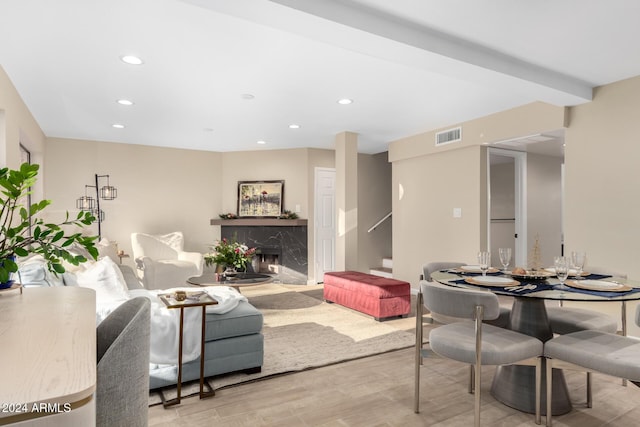 living room with a premium fireplace and light wood-type flooring