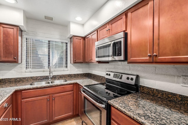 4414 E Hubbell St Unit 66, Phoenix, AZ 85008 - kitchen featuring stainless steel appliances, dark stone counters, decorative backsplash, and recessed lighting