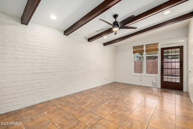 4414 E Hubbell St Unit 66, Phoenix, AZ 85008 - empty room with brick wall, ceiling fan, beamed ceiling, light tile patterned floors, and recessed lighting