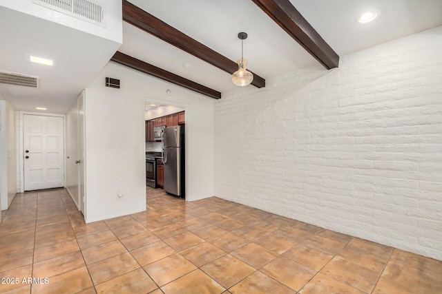 4414 E Hubbell St Unit 66, Phoenix, AZ 85008 - spare room with brick wall, beamed ceiling, and light tile patterned floors