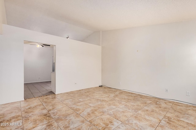tiled spare room with lofted ceiling, a textured ceiling, and ceiling fan