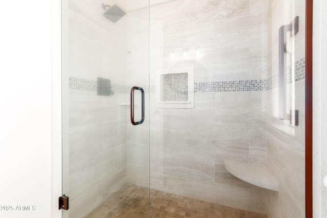 bathroom with a shower with door