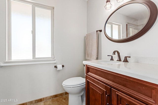 bathroom featuring vanity, tile patterned floors, and toilet