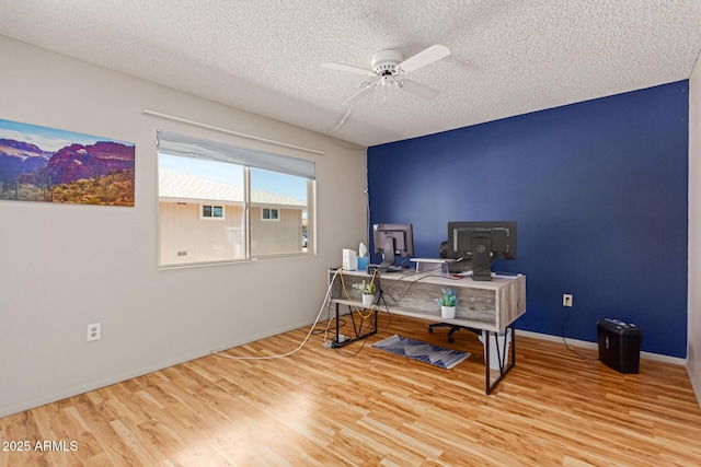 office area with ceiling fan, a textured ceiling, and light hardwood / wood-style flooring