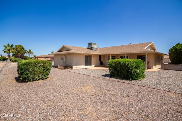 rear view of house with a patio area and central air condition unit