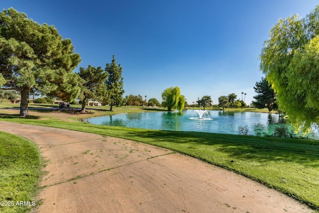 view of community featuring a water view and a lawn