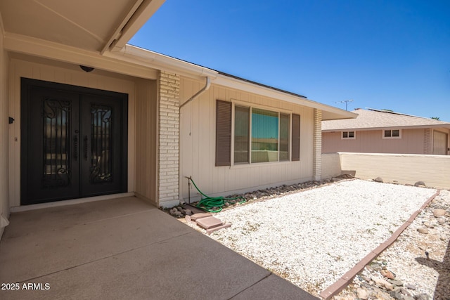 entrance to property featuring a patio area and french doors