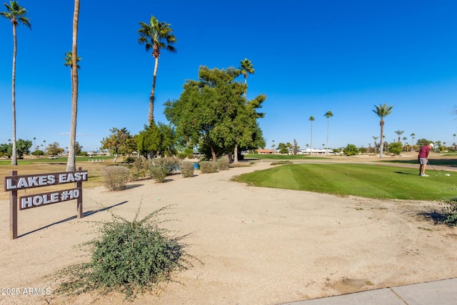 view of property's community with a lawn