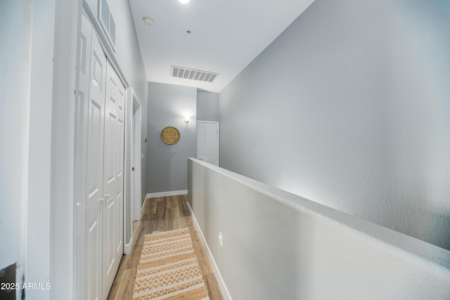 2402 E 5th St Unit 1498, Tempe, AZ 85288 - hall featuring light wood-type flooring, baseboards, and an upstairs landing