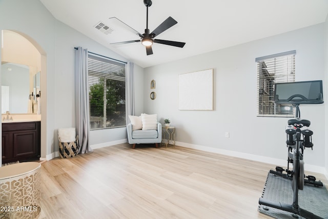 2402 E 5th St Unit 1498, Tempe, AZ 85288 - workout area featuring light wood-style flooring, vaulted ceiling, arched walkways, ceiling fan, and a sink