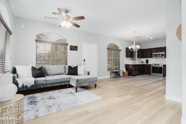 2402 E 5th St Unit 1498, Tempe, AZ 85288 - living area with a chandelier, light wood finished floors, ceiling fan, and baseboards