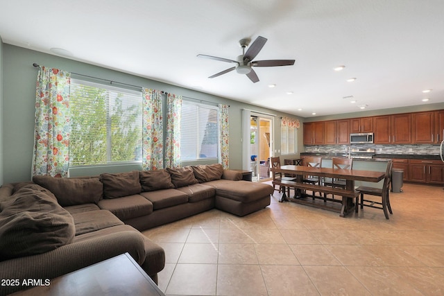 living room featuring light tile patterned flooring and ceiling fan