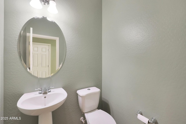 bathroom featuring sink and toilet