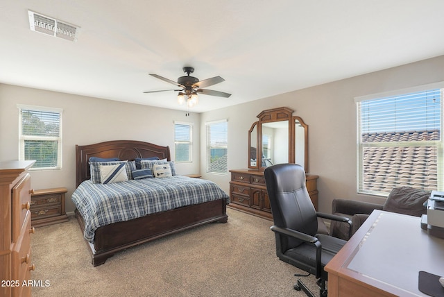 bedroom featuring light carpet and ceiling fan