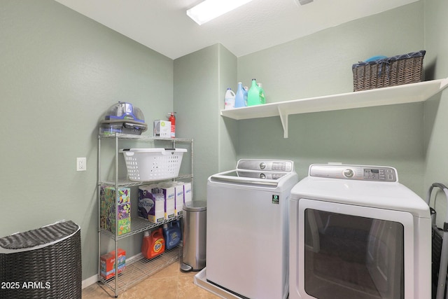 washroom with light tile patterned flooring and washer and dryer