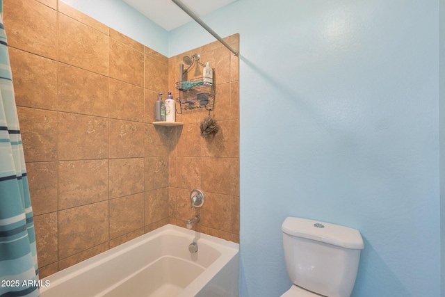 bathroom featuring toilet and shower / bath combo with shower curtain