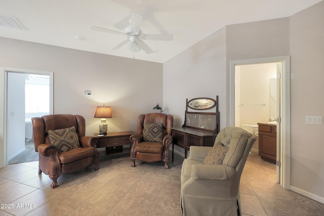 sitting room featuring ceiling fan, lofted ceiling, and light tile patterned floors