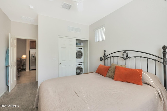 bedroom with carpet, stacked washer / drying machine, ceiling fan, and stainless steel fridge with ice dispenser