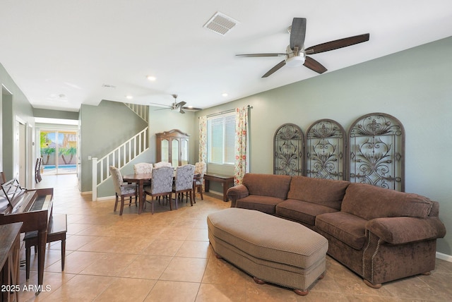 tiled living room with ceiling fan