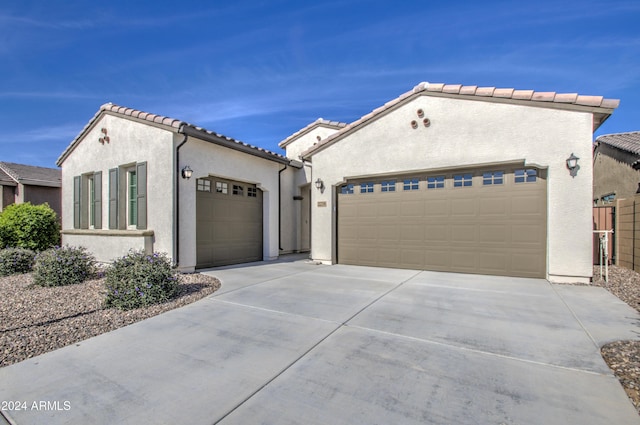2228 E Isaiah Ave, Gilbert, AZ 85298 - mediterranean / spanish house with a garage, driveway, stucco siding, and a tiled roof