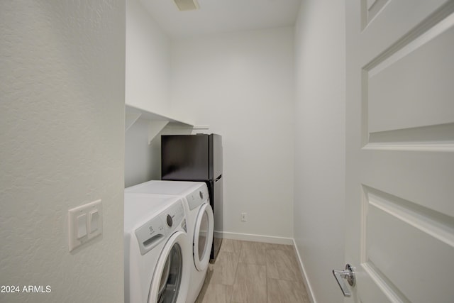 2228 E Isaiah Ave, Gilbert, AZ 85298 - laundry area with washer and clothes dryer, baseboards, and a textured wall
